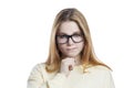 Thoughtful red-haired young girl in glasses and a yellow sweater. Close-up. Isolated on white background Royalty Free Stock Photo