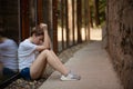 Woman looking down sadly thinking sitting on the floor Royalty Free Stock Photo