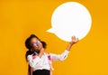 Thoughtful School Girl Holding Speech Bubble Thinking On Yellow Background