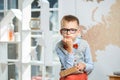 A thoughtful schoolboy sits at a desk with books Royalty Free Stock Photo