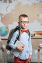 A thoughtful schoolboy sits at a desk with books Royalty Free Stock Photo