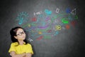 Thoughtful schoolgirl looking at doodles in a class Royalty Free Stock Photo