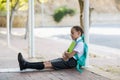 Thoughtful schoolgirl sitting alone in corridor Royalty Free Stock Photo