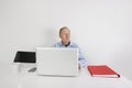 Thoughtful senior businessman using laptop at office desk Royalty Free Stock Photo