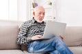 Thoughtful senior man reading news on laptop Royalty Free Stock Photo