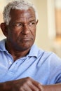 Thoughtful Senior Man Sitting On Sofa At Home Royalty Free Stock Photo