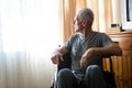 Thoughtful senior man sitting on wheelchair in nursing home Royalty Free Stock Photo