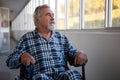 Thoughtful senior man sitting on wheelchair in nursing home Royalty Free Stock Photo