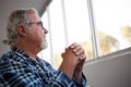 Thoughtful senior man sitting on wheelchair in retirement home Royalty Free Stock Photo
