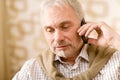 Thoughtful senior mature man with mobile phone Royalty Free Stock Photo