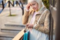 Thoughtful senior woman standing near the building Royalty Free Stock Photo