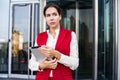 Thoughtful serious female office worker outdoors