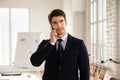 Thoughtful serious young business professional man speaking on cellphone Royalty Free Stock Photo