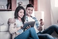 Smiling appealing couple sitting on the cozy couch