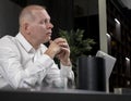 Thoughtful smart businessman sitting at office desk and thinking of future plans, ideas, problems, strategy, new chances Royalty Free Stock Photo