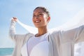 Thoughtful smiling woman against sky at beach Royalty Free Stock Photo