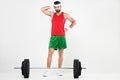 thoughtful sportsman standing near barbell