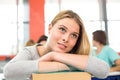 Thoughtful student with books in classroom Royalty Free Stock Photo