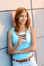 Thoughtful student girl standing by modern wall Royalty Free Stock Photo