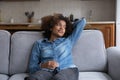 Thoughtful teen girl relaxing on comfortable sofa in living room Royalty Free Stock Photo