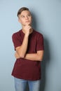 Thoughtful teenage boy on color background Royalty Free Stock Photo