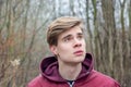 Thoughtful teenager boy portrait in nature park outdoor Royalty Free Stock Photo