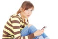 Thoughtful teenager with cell phone