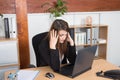 Thoughtful tired businesswoman sitting at desk looking at computer Royalty Free Stock Photo