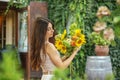 Thoughtful Woman Admiring a Bouquet of Sunflowers
