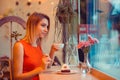 Thoughtful woman while eating sweet dessert and drinking tea Royalty Free Stock Photo