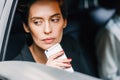 Thoughtful woman holding a cell phone Royalty Free Stock Photo