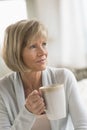 Thoughtful Woman Holding Coffee Mug At Home Royalty Free Stock Photo