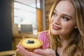 Thoughtful woman holding cupcake Royalty Free Stock Photo