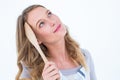 Thoughtful woman holding wooden spatula