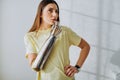 Thoughtful woman with metal bionic prosthesis arm in room Royalty Free Stock Photo