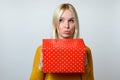 Thoughtful Woman with Pouting Lips Holding Present