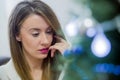 Thoughtful woman reading book in christmas decorated home. Holiday concept, christmas, holidays and people concept.