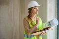 Thoughtful woman realtor holds pencil near her face