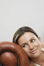 Thoughtful Woman Relaxing On Sofa's Armrest Royalty Free Stock Photo