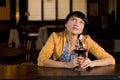 Thoughtful woman sitting at the bar