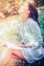 Thoughtful Woman Sitting on Grasses at the Garden