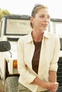 Thoughtful Woman Standing In Front Of Car Royalty Free Stock Photo