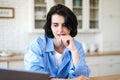 Thoughtful woman working at laptop and think about project