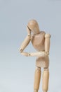 Thoughtful wooden figurine pretending to lean