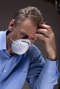Thoughtful worried physician with medical mask in a hospital