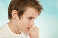 Thoughtful worried young boy biting his nails Royalty Free Stock Photo