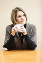 Thoughtful yong woman drinking coffee Royalty Free Stock Photo