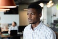 Thoughtful young african american businessman in creative office Royalty Free Stock Photo