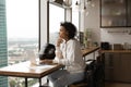 Thoughtful young african american businesswoman working on online project. Royalty Free Stock Photo