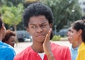 Thoughtful young african american man with friends Royalty Free Stock Photo